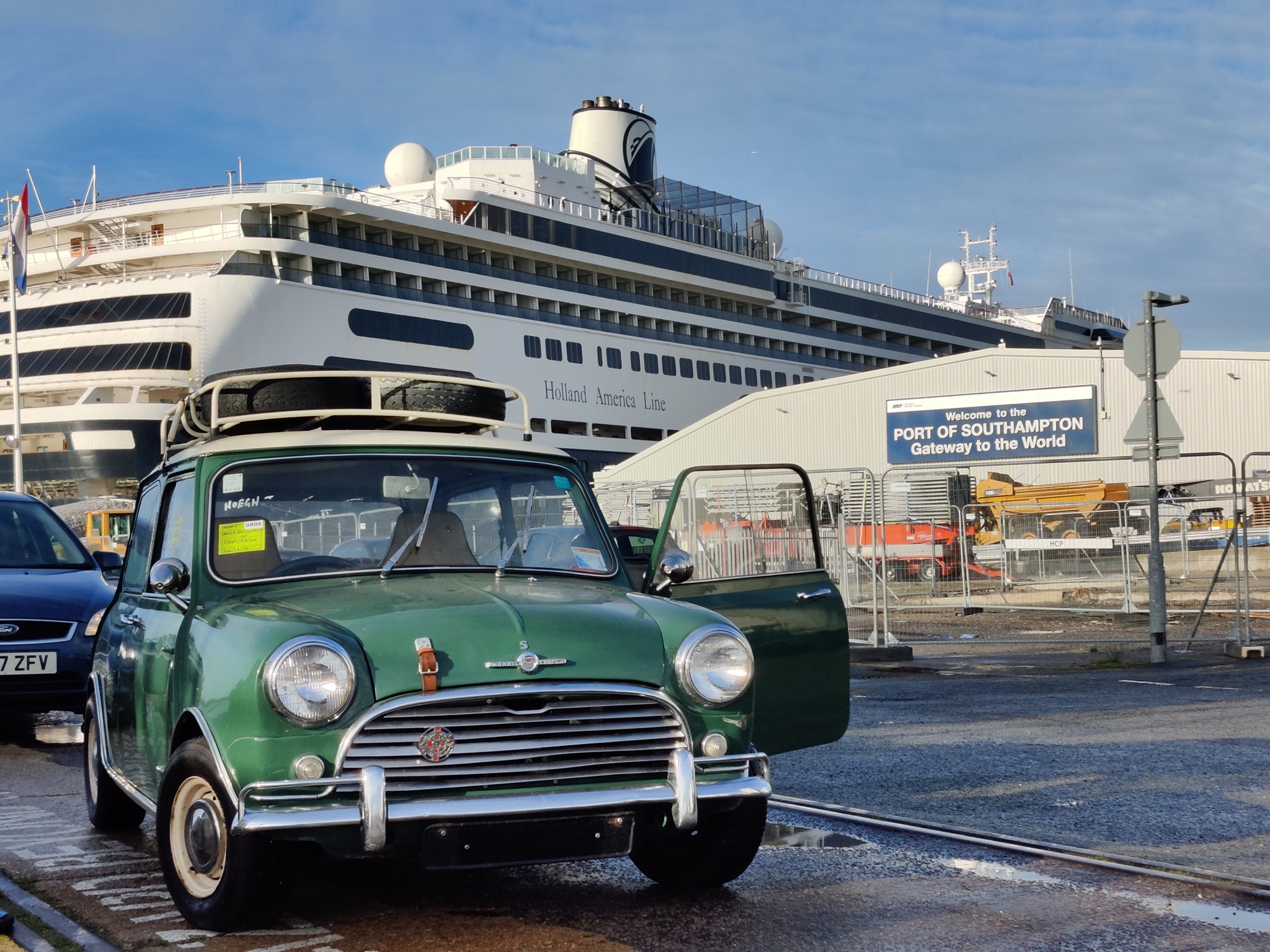 A classic Mini car at a dockyard, freshly offloaded from a ship in Southampton